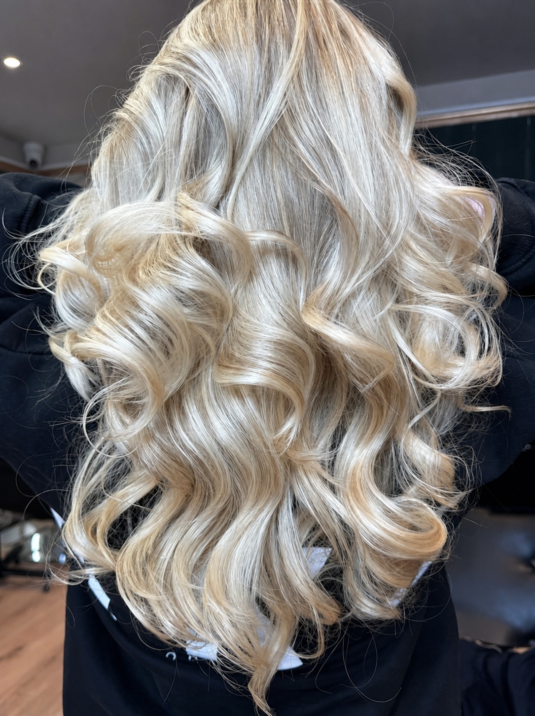 Platinum blonde curls created at Miramor Salon